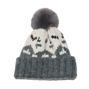Close-up of winter mohair knit beanie featuring grey pompom and geometric pattern