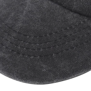 Macro detail of dark grey washed canvas baseball cap brim with precise reinforced stitching