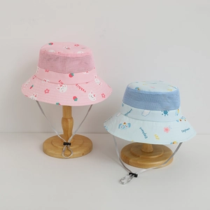 Detail view of children's mesh bucket hat with cartoon prints and adjustable chin strap