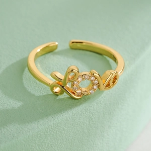 Macro shot of gold plated adjustable LOVE ring featuring a sparkling zircon stone O