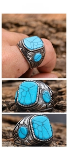 Detailed macro view of vintage stainless steel ring with turquoise stone and rope texture