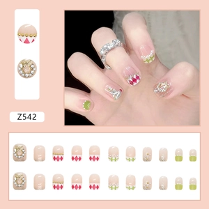 Pastel pink and green checkered press-on nails with 3D pearls and golden bow accents