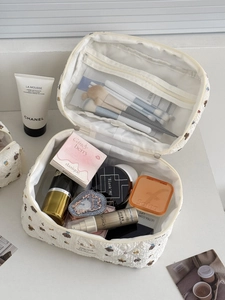 Quilted white cosmetic bag with cute bear print and organized interior compartments