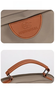Detail of waterproof nylon handbag with premium leather handle and embossed logo brand mark