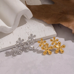 Elegant floral stud earrings in polished gold and silver finish with 3D petal design