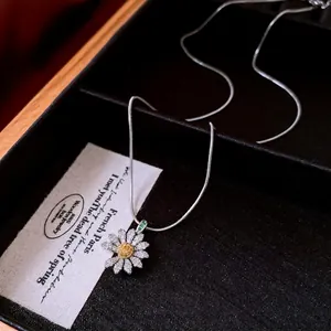 Daisy pendant necklace with white cubic zirconia and yellow micro-pave center in silver