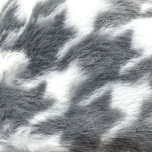 Macro detail of plush grey and white faux fox fur with soft dense texture and long fibers