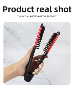 Detail of red and black V-shaped hair straightener brush with ergonomic long handle