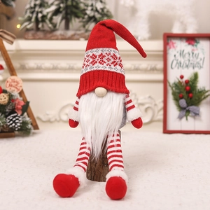 Detail of Christmas gnomes ornaments featuring knitted hats and plush white beards on wood