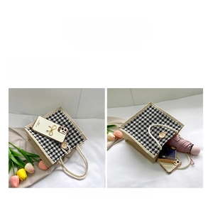Detailed internal capacity of houndstooth tote bag showing storage for umbrella and phone