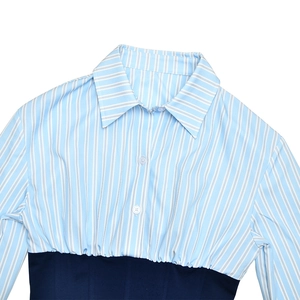 Detail of blue striped shirt collar with navy blue waist splicing on white background