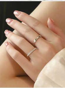 Macro detail of silver stackable rings featuring pavé diamonds and star engraving