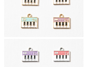 Macro shot of colorful alloy piano keyboard charms with gold and silver borders