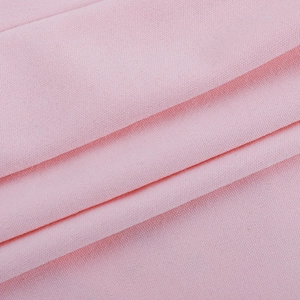 Close-up of soft pink ribbed knit fabric showing fine texture and premium material detail
