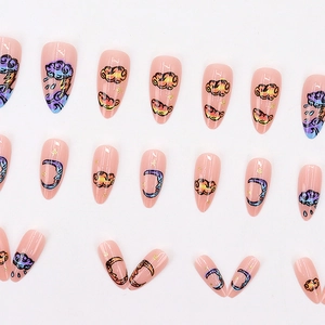 Pink stiletto press-on nails with cartoon clouds, lightning, and moon doodle designs