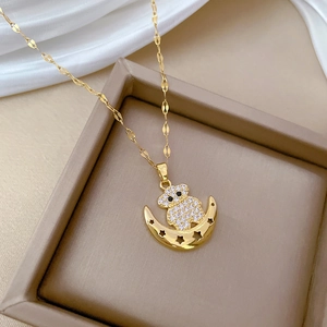 Luxurious gold moon and bear pendant necklace with sparkling zircons in a jewelry box