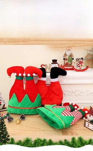 Detailed view of plush Christmas elf leg hats with bells and festive decorations