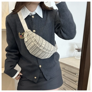 Chic beige striped crossbody chest bag styled with casual knitwear for women