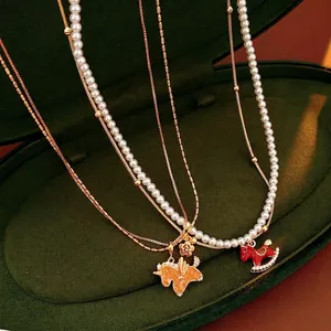 Elegant pearl necklace with red enamel pony pendant displayed in a luxury velvet box