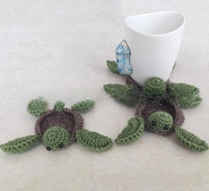 Detailed close-up of handmade crochet turtle coasters for mugs and thermal insulation