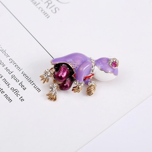 Detailed macro view of vintage purple frog brooch with enamel finish and pink gemstone