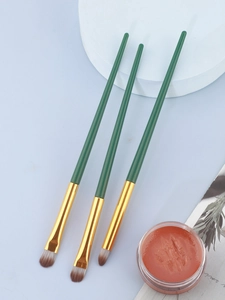 Three precision makeup brushes with dark green handles and synthetic bristles for eye makeup