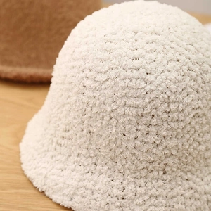 Close-up of soft white lamb wool bucket hat showcasing thick plush texture and warmth