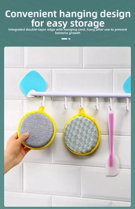 Close-up of circular kitchen sponge showing reinforced yellow edging and integrated hanging loop