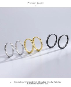 Macro detail of S925 sterling silver hoop earrings in silver, gold, and black finish