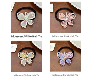 Four colors of iridescent butterfly elastic hairbands displayed on a dark wood background