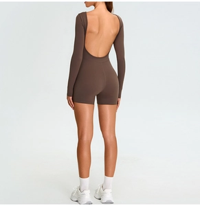 Close-up of the deep open back design on a brown long sleeve yoga romper