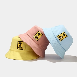 Summer canvas bucket hats with 'Go Away' palm tree patches in yellow, pink and blue