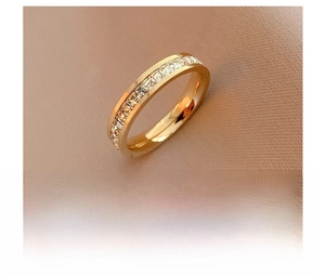 Macro view of gold titanium steel ring with sparkling square crystal row setting