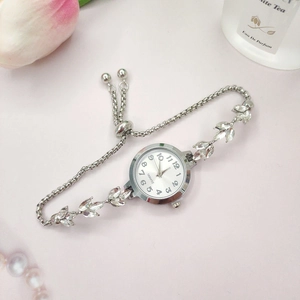 Détail de la montre femme argentée avec bracelet en feuilles de cristal et fermoir coulissant