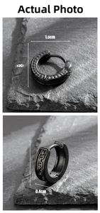 Macro view of black steel earrings showing chain texture and dimensions on stone
