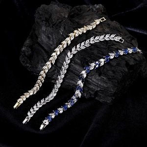 Detailed view of marquise-cut crystal bracelets in gold, silver, and blue sapphire stones