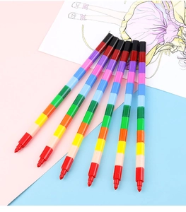 Close-up of 6 rainbow building block crayons for kids on a pink and blue background