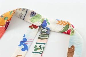 Detail of colorful print fabric with two white buttons on cotton-linen clothing