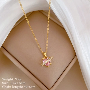 Close-up of pink heart crystal necklace in gold with diamonds and dimension details