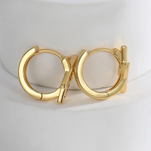 Minimalist gold geometric hoop earrings with polished metal finish and zircon accents
