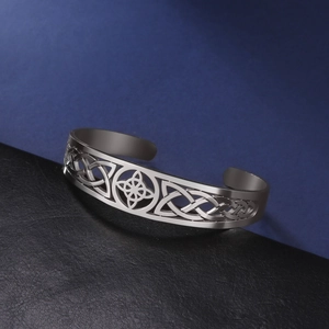 Celtic knot cutout stainless steel open bangle bracelet with a polished metallic finish