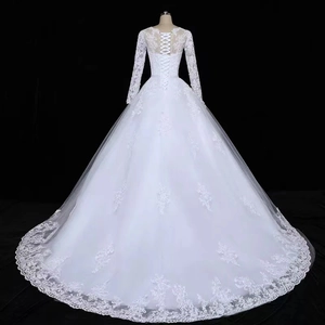 Elegant white long-sleeved bridal gown with lace embroidery and corset back design