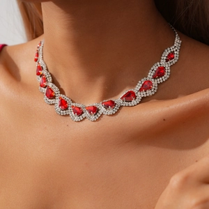 Close-up of elegant red teardrop gemstone necklace with micro-pave crystals on model