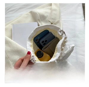 Internal view of white lace handbag showing storage capacity for phone and wallet