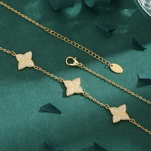 Elegant gold necklace with three floral clover pendants pavé-set with white zircons