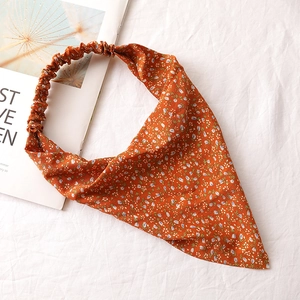 Detail shot of orange floral chiffon headscarf with blue flowers and elastic band