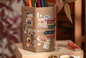 Detail of hexagonal stationery organizer with vintage food-themed decorative stickers