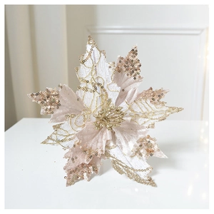 Detail of champagne gold Christmas poinsettia with sparkling sequins and fabric texture
