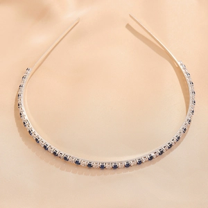 Detail of silver metal headband featuring alternating blue and white round gemstones