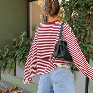 Red and white striped long sleeve T-shirt for women in a stylish street style shot